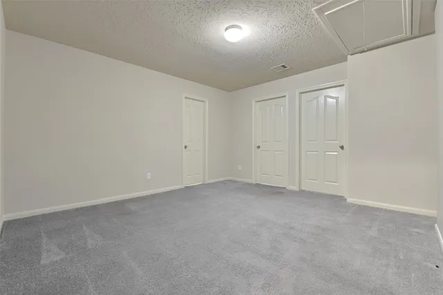 an empty room with closet and a ceiling fan