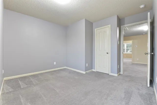 an empty room and chandelier fan