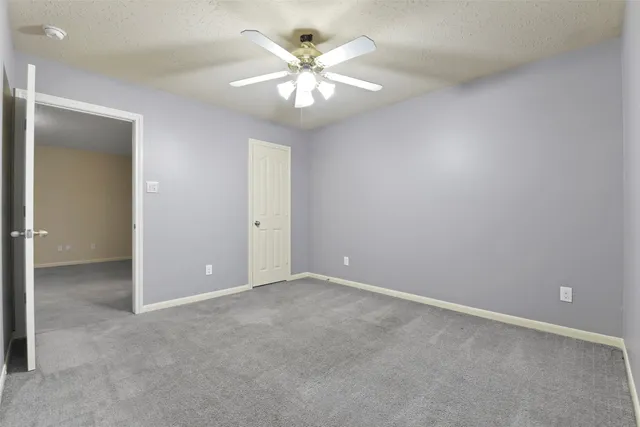 a front view of a house with a garden and yard