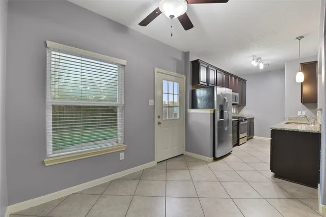 a kitchen with stainless steel appliances granite countertop a sink refrigerator and stove