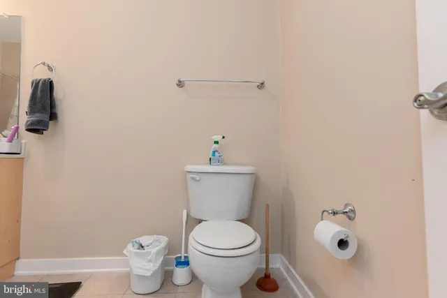 a white toilet sitting next to a bathroom sink