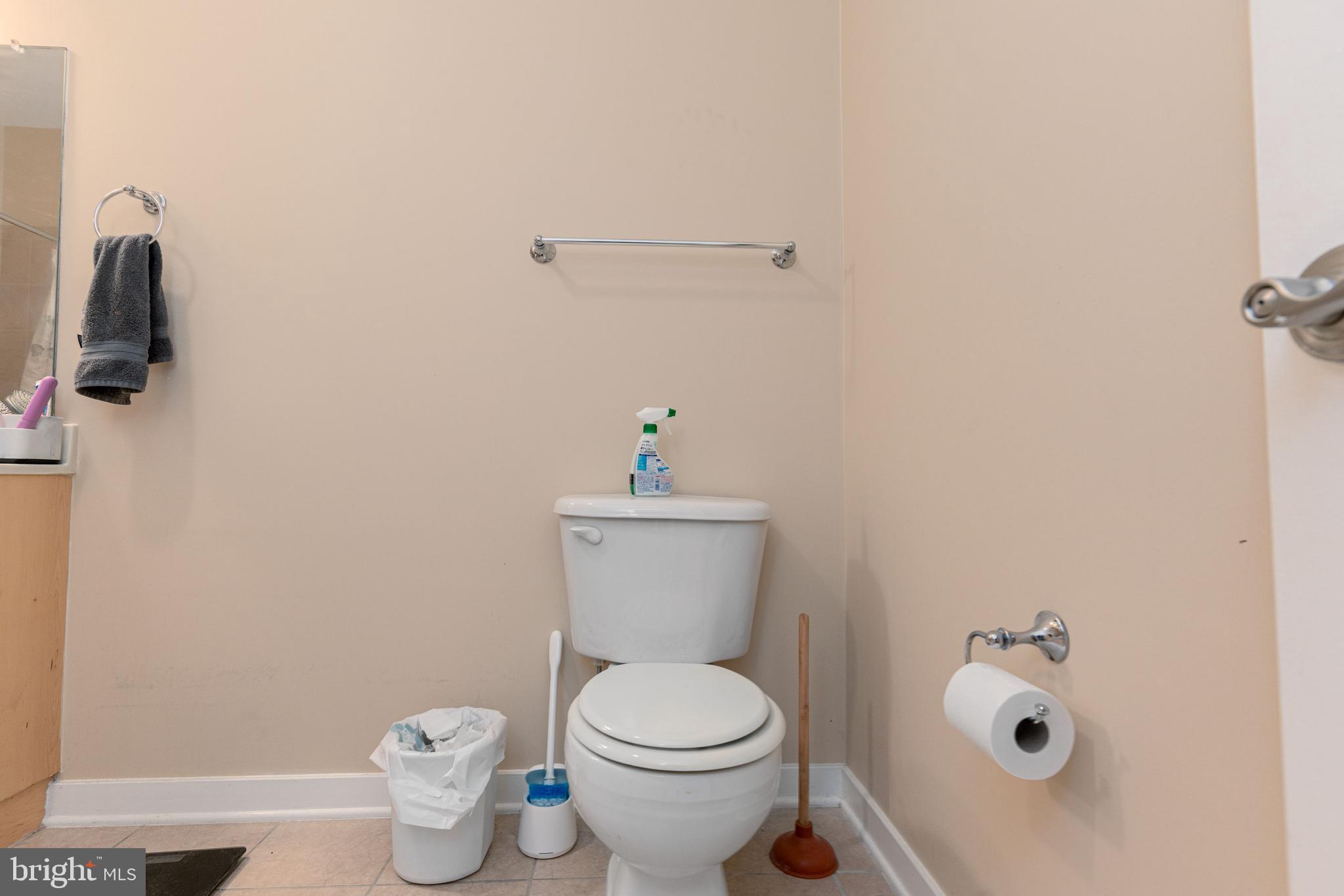3201 St Paul Street, Unit 422 Baltimore, MD 21218 - Photo 11 of 27 a white toilet sitting next to a bathroom sink