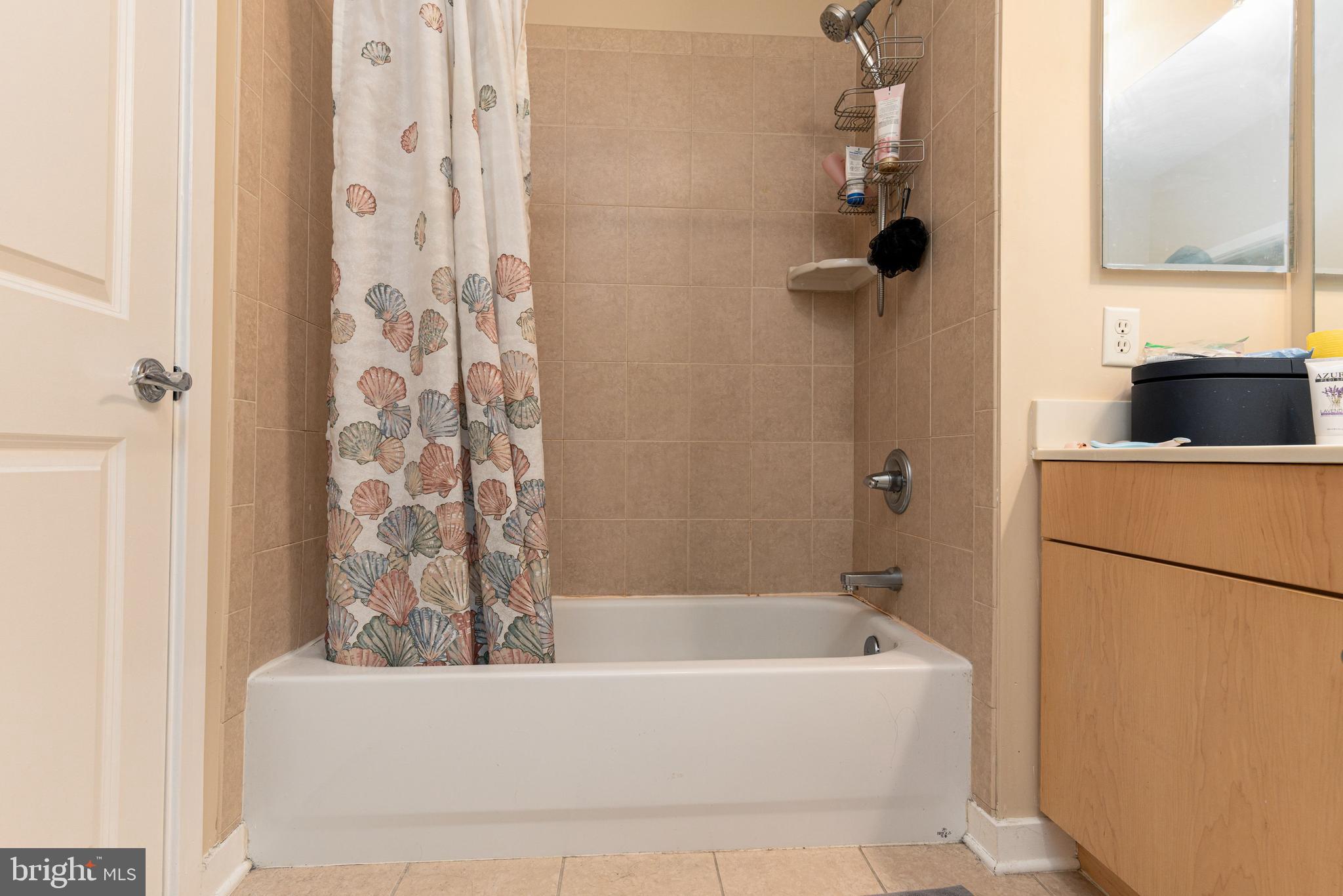 3201 St Paul Street, Unit 422 Baltimore, MD 21218 - Photo 13 of 27 a bathroom with a bathtub and shower