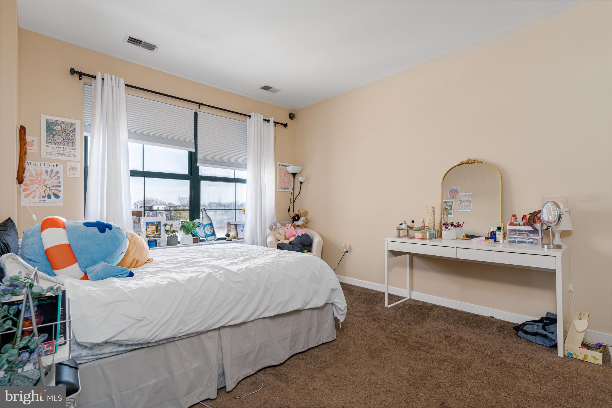 3201 St Paul Street, Unit 422 Baltimore, MD 21218 - Photo 18 of 27 a bedroom with a bed and window