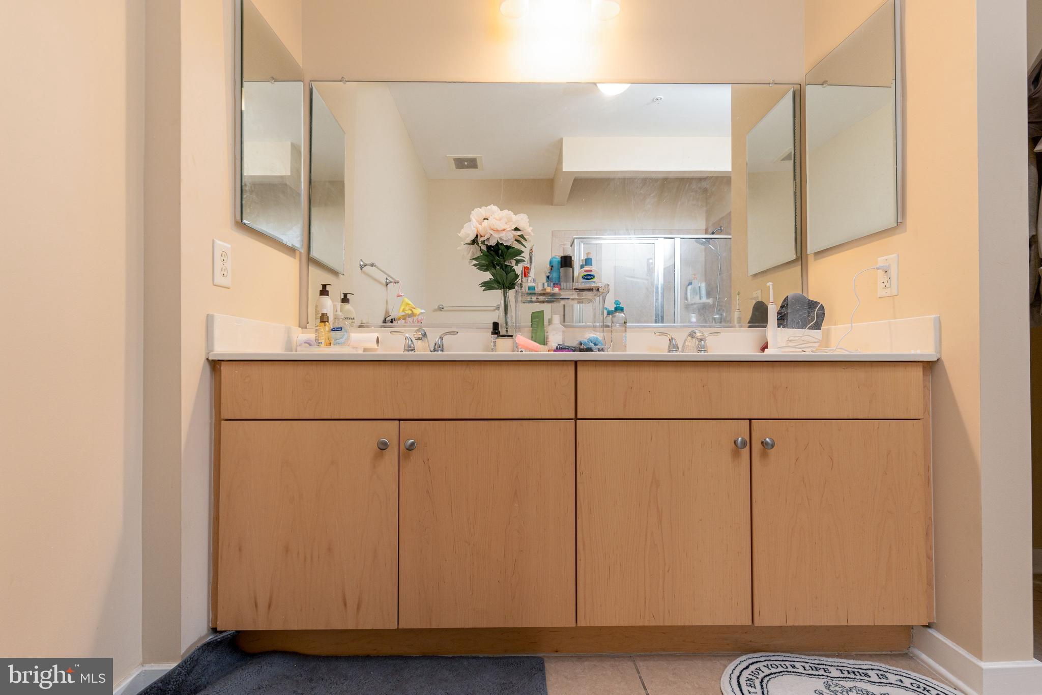 3201 St Paul Street, Unit 422 Baltimore, MD 21218 - Photo 23 of 27 a bathroom with a sink and a mirror