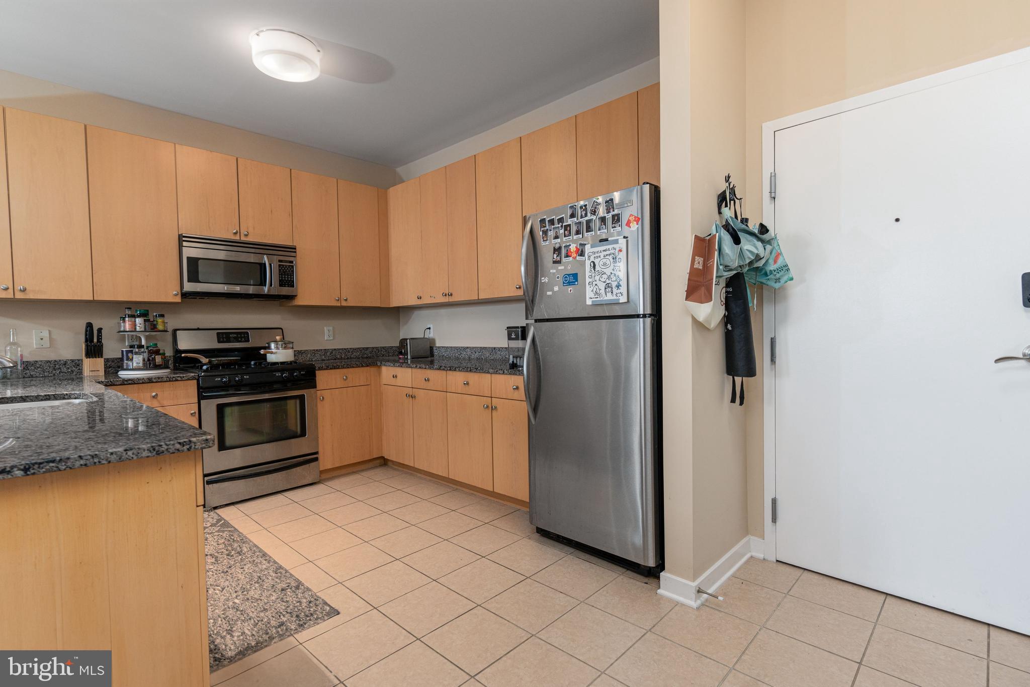 3201 St Paul Street, Unit 422 Baltimore, MD 21218 - Photo 4 of 27 a kitchen with a refrigerator sink and microwave