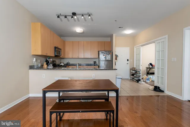 a kitchen with kitchen island a table and chairs in it
