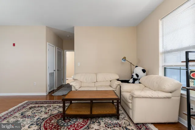 a living room with a couch and a rug