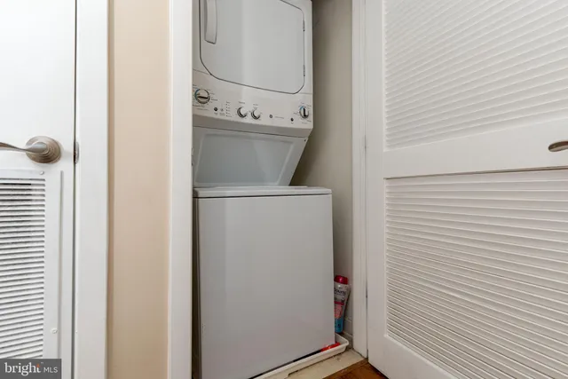 a view of a storage and utility room with washer and dryer
