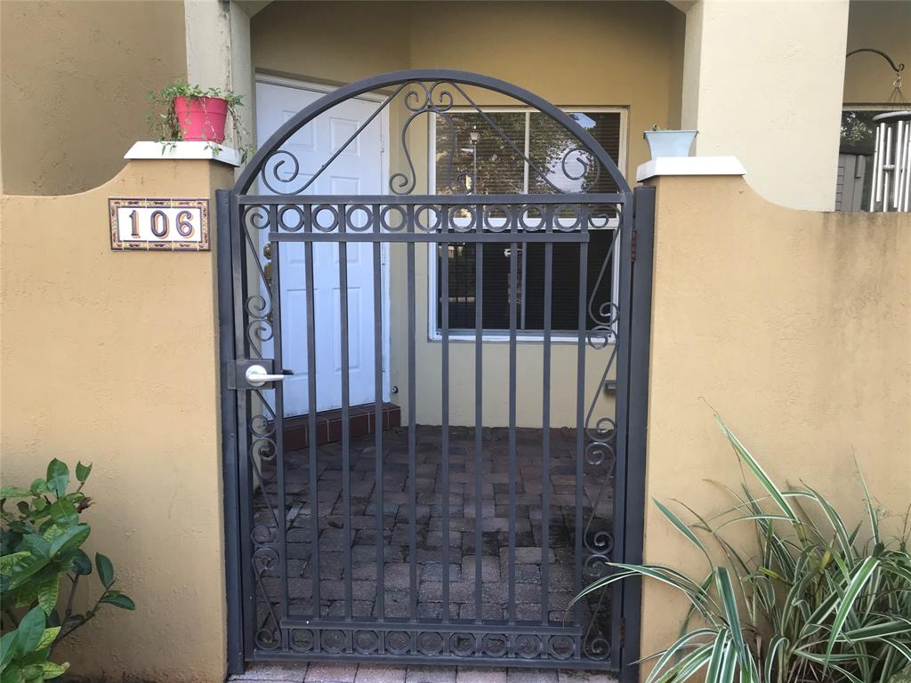 2851 Prospect Road, Unit 106 Fort Lauderdale, FL 33309 - Photo 2 of 6 a view of a hallway with a flower garden
