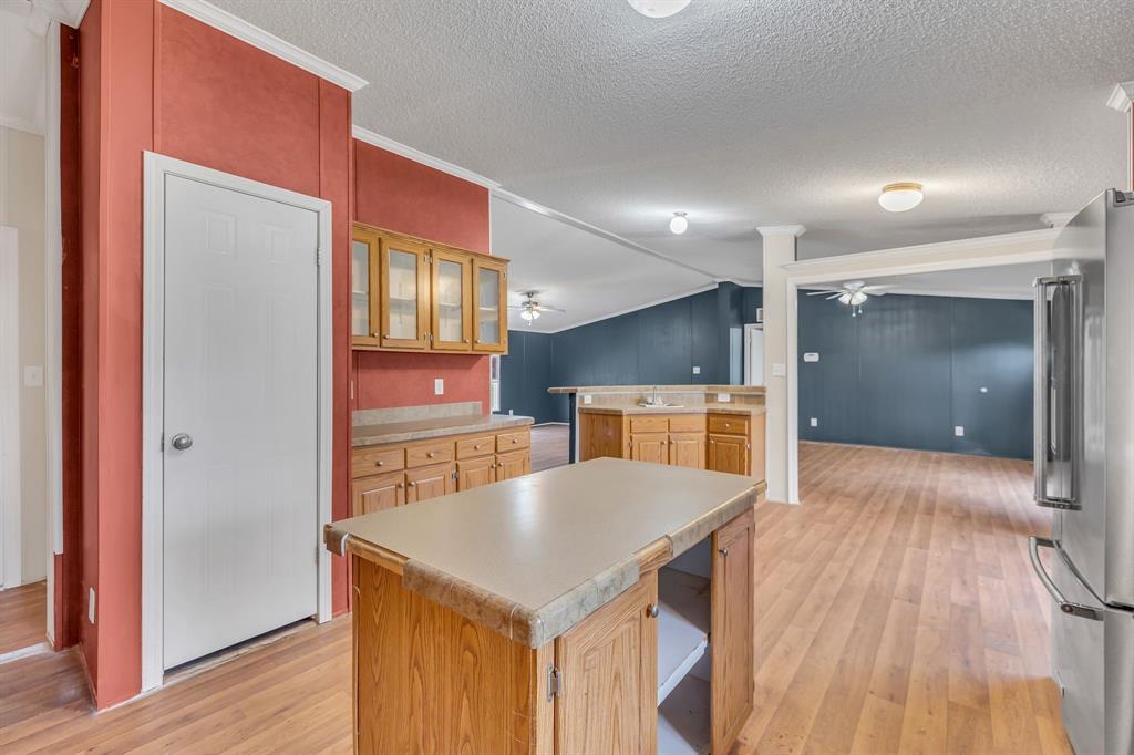 1350 Stephens Road Millsap, TX 76066 - Photo 13 of 29 a kitchen with a refrigerator a sink and wooden floor