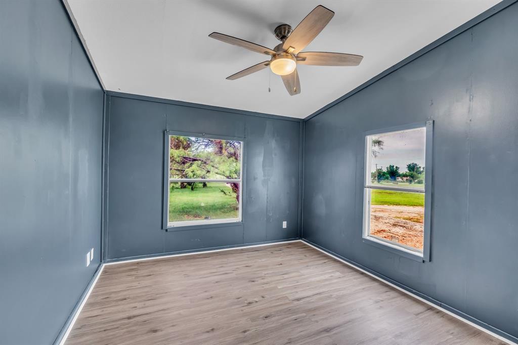 1350 Stephens Road Millsap, TX 76066 - Photo 16 of 29 an empty room with window and ceiling fan