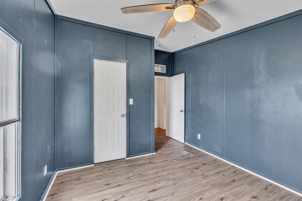 1350 Stephens Road Millsap, TX 76066 - Photo 17 of 29 a bedroom with a bed and a chandelier