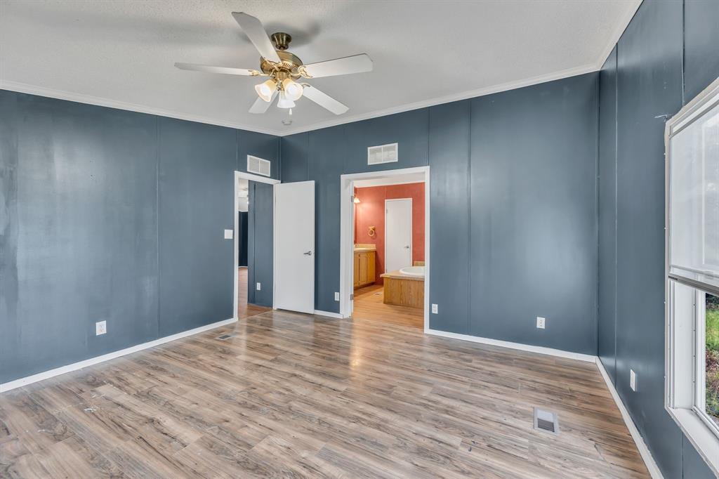 1350 Stephens Road Millsap, TX 76066 - Photo 21 of 29 a view of an empty room with window and wooden floor