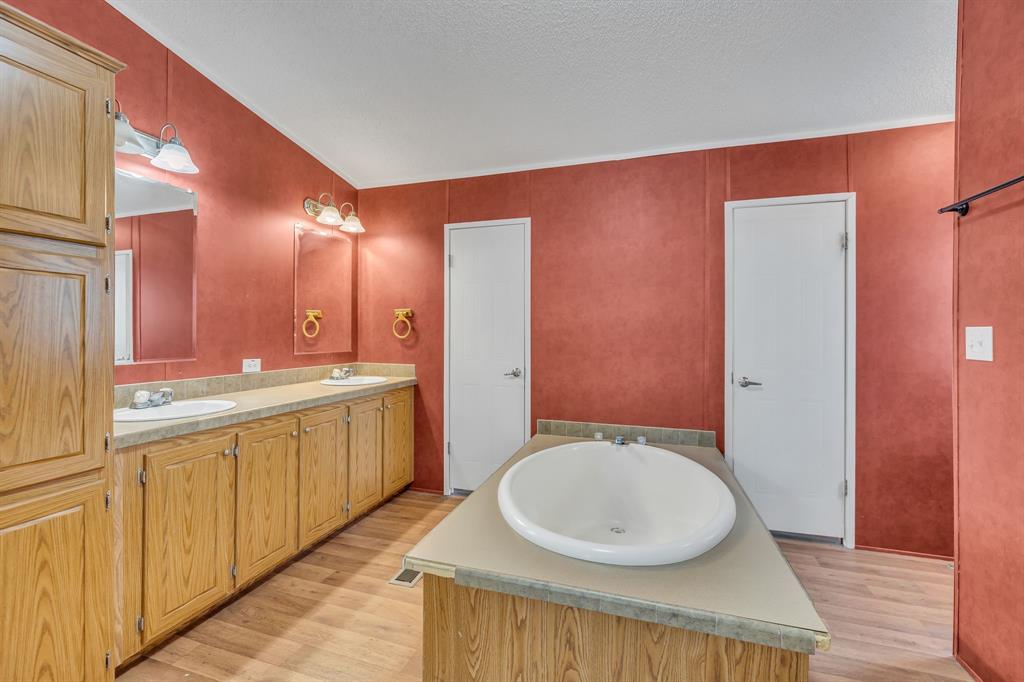 1350 Stephens Road Millsap, TX 76066 - Photo 22 of 29 a bathroom with a sink a toilet and mirror