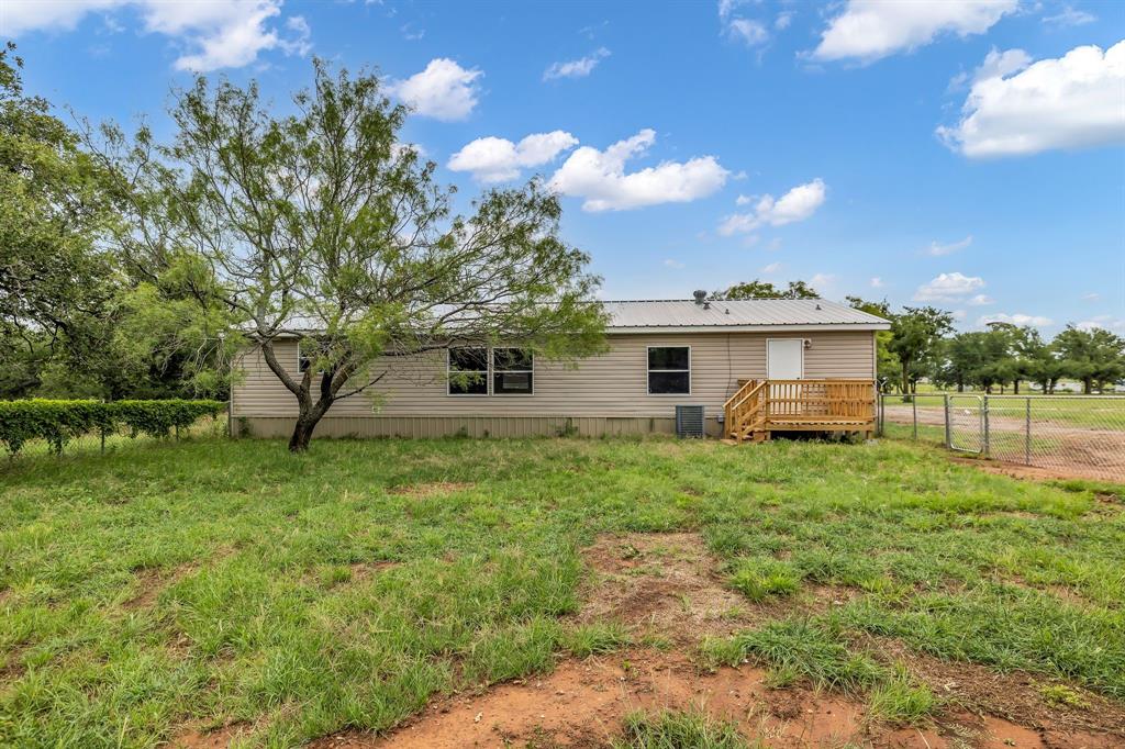 1350 Stephens Road Millsap, TX 76066 - Photo 26 of 29 a view of a backyard with plants and large trees