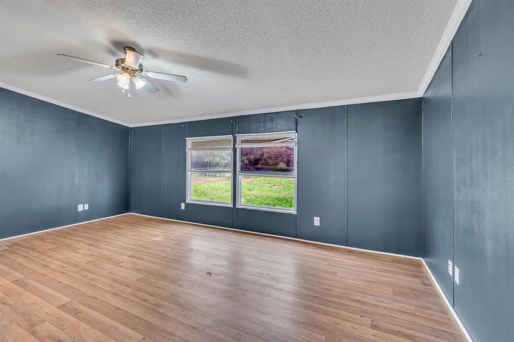 1350 Stephens Road Millsap, TX 76066 - Photo 6 of 29 a view of an empty room with window and wooden floor