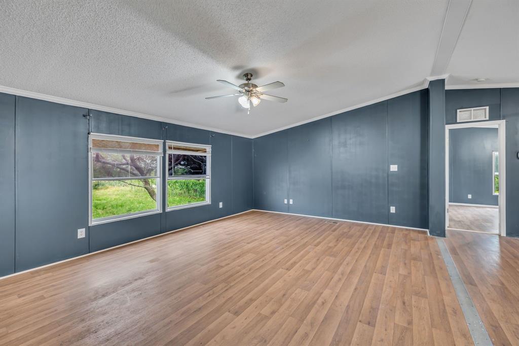 1350 Stephens Road Millsap, TX 76066 - Photo 7 of 29 a view of an empty room with a window and wooden floor