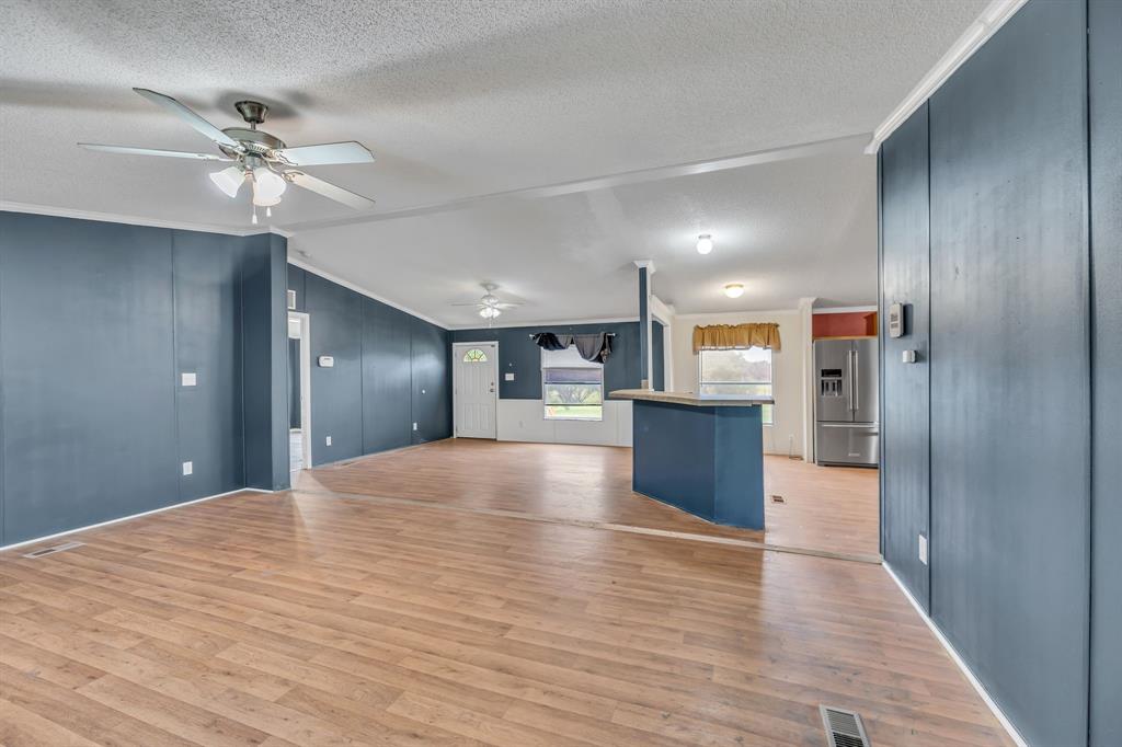 1350 Stephens Road Millsap, TX 76066 - Photo 8 of 29 a view of a kitchen with a sink and a refrigerator