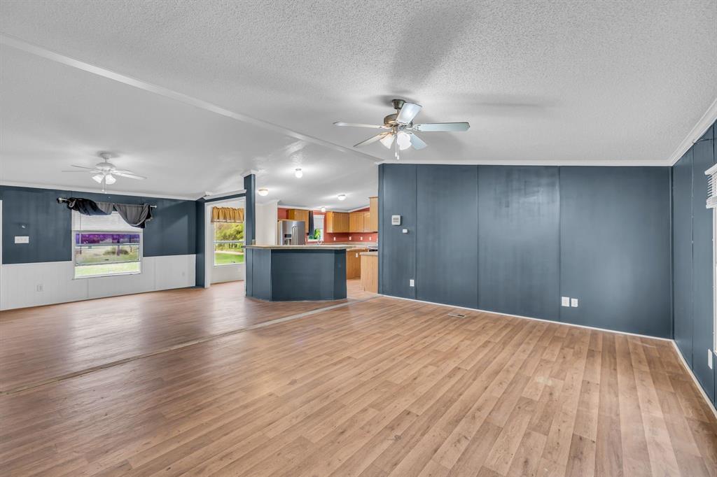 1350 Stephens Road Millsap, TX 76066 - Photo 9 of 29 a view of an empty room with a kitchen and a stove top oven
