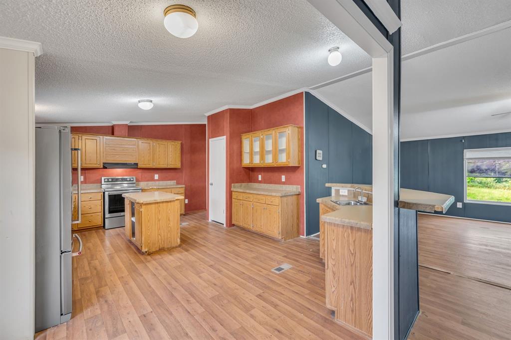 1350 Stephens Road Millsap, TX 76066 - Photo 10 of 29 a open kitchen with a sink and dishwasher a oven with a large window