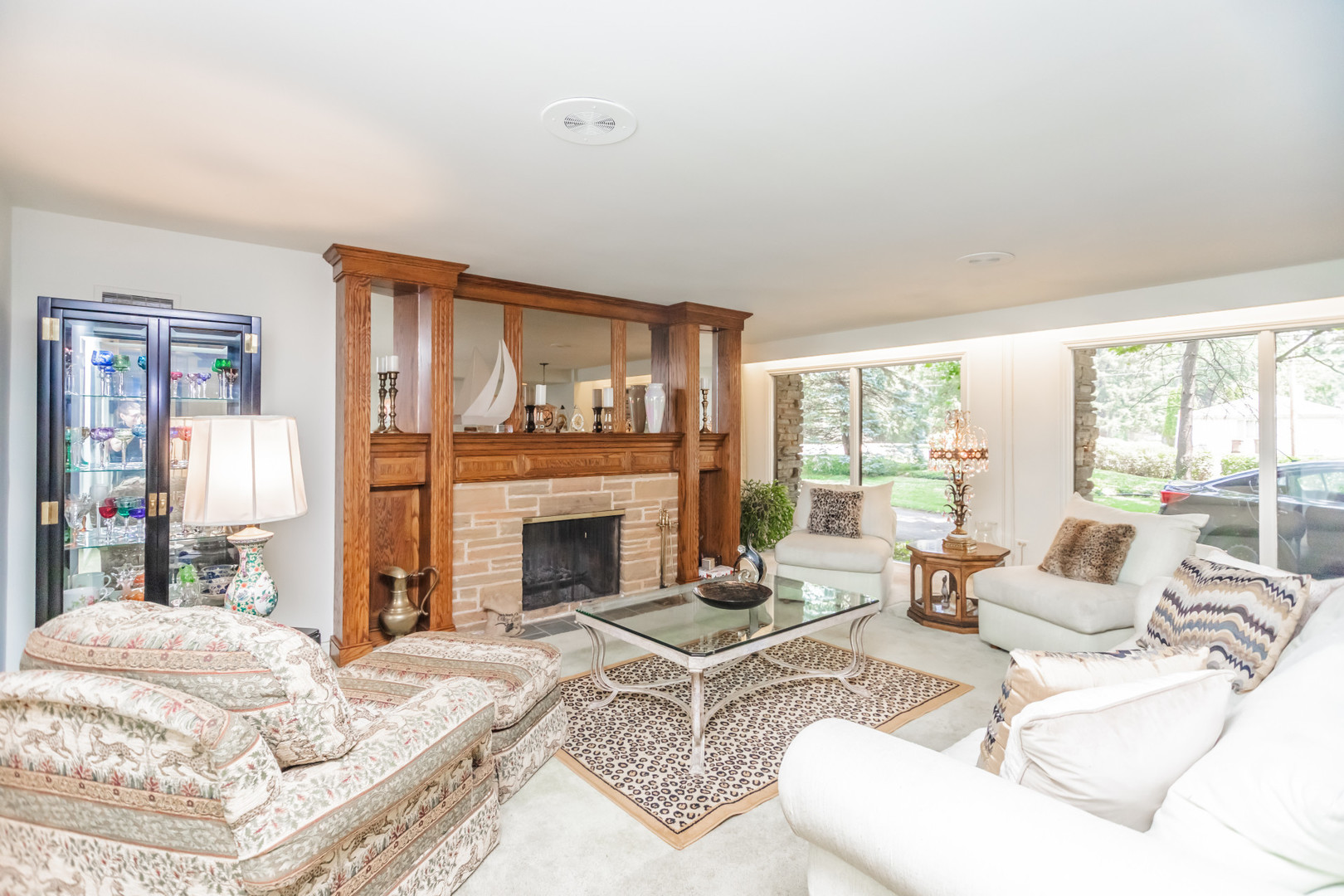 8080 Wolf Road Burr Ridge, IL 60527 - Photo 12 of 73 a living room with furniture a fireplace and a large window with outer view