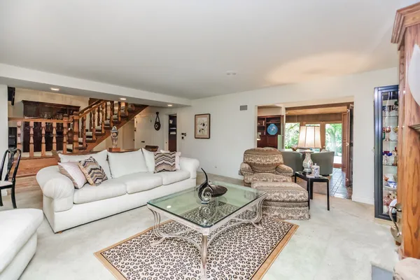 a dining room with furniture a chandelier and wooden floor