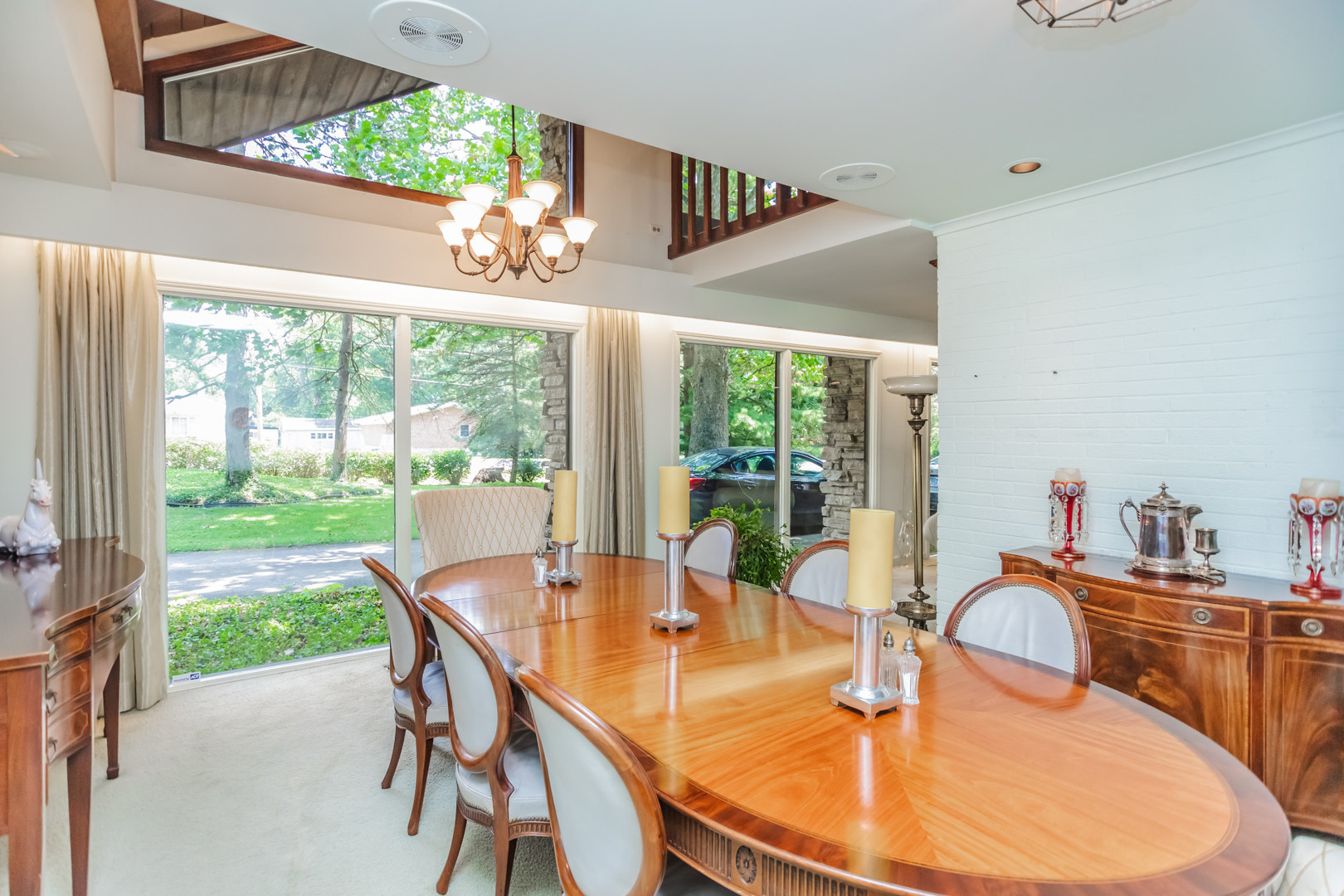 8080 Wolf Road Burr Ridge, IL 60527 - Photo 17 of 73 a dining room with furniture a chandelier and wooden floor