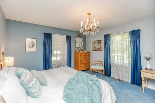 a bed room with a bed and a large window