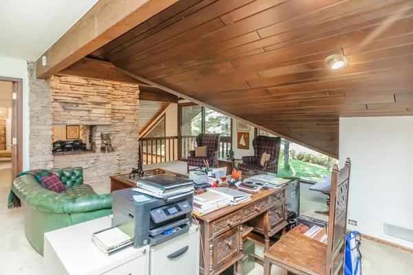 a room with musical instrument pool table and windows
