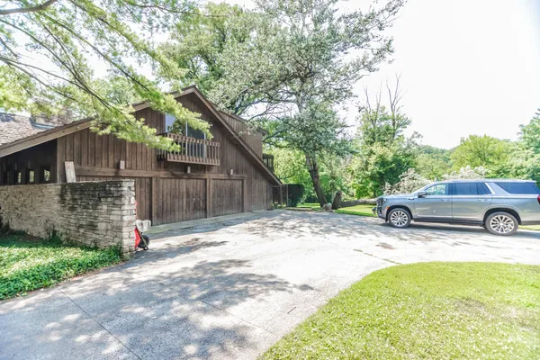 a view of a wooden house with a tree