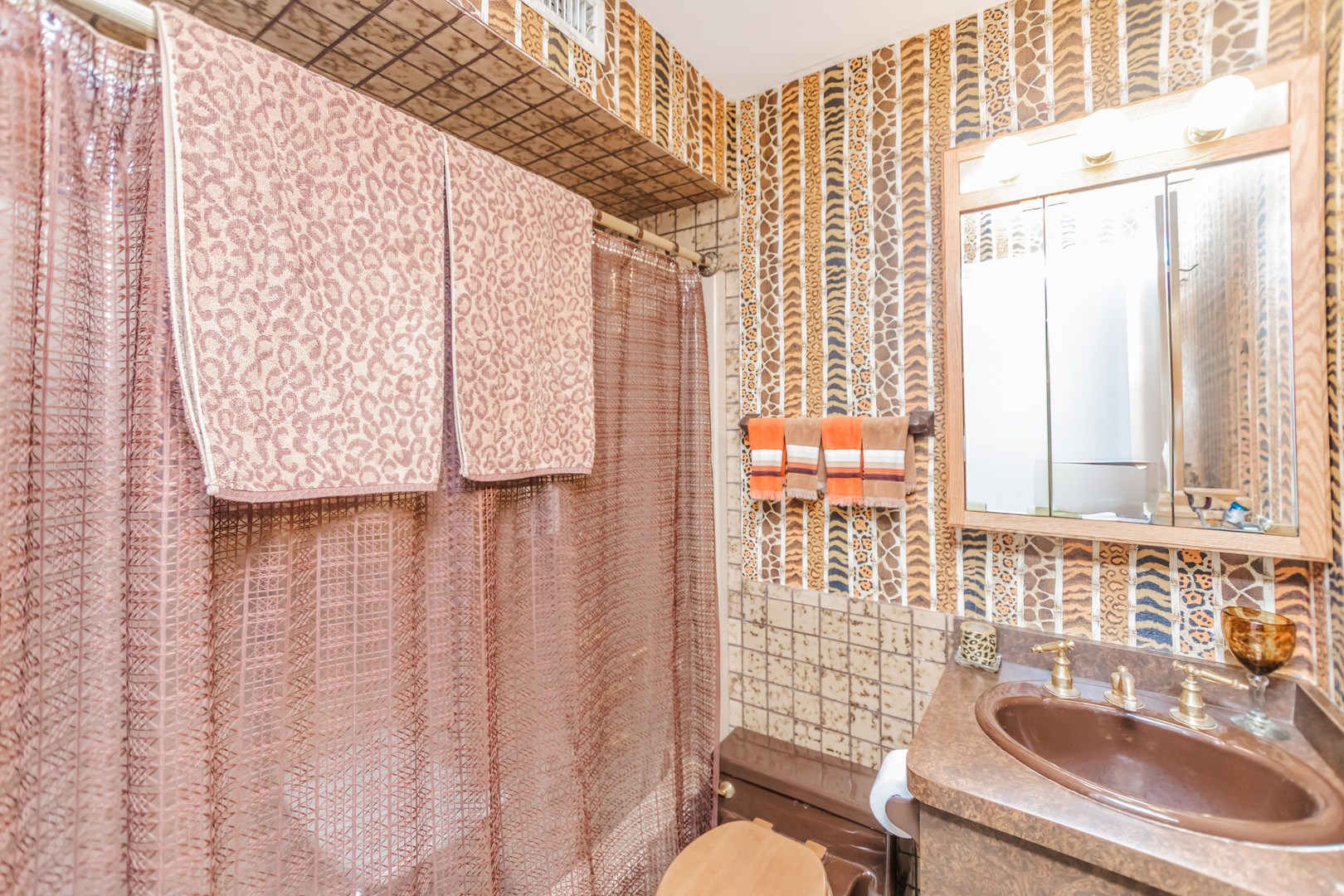 8080 Wolf Road Burr Ridge, IL 60527 - Photo 43 of 73 a bathroom with a sink a toilet and shower curtain