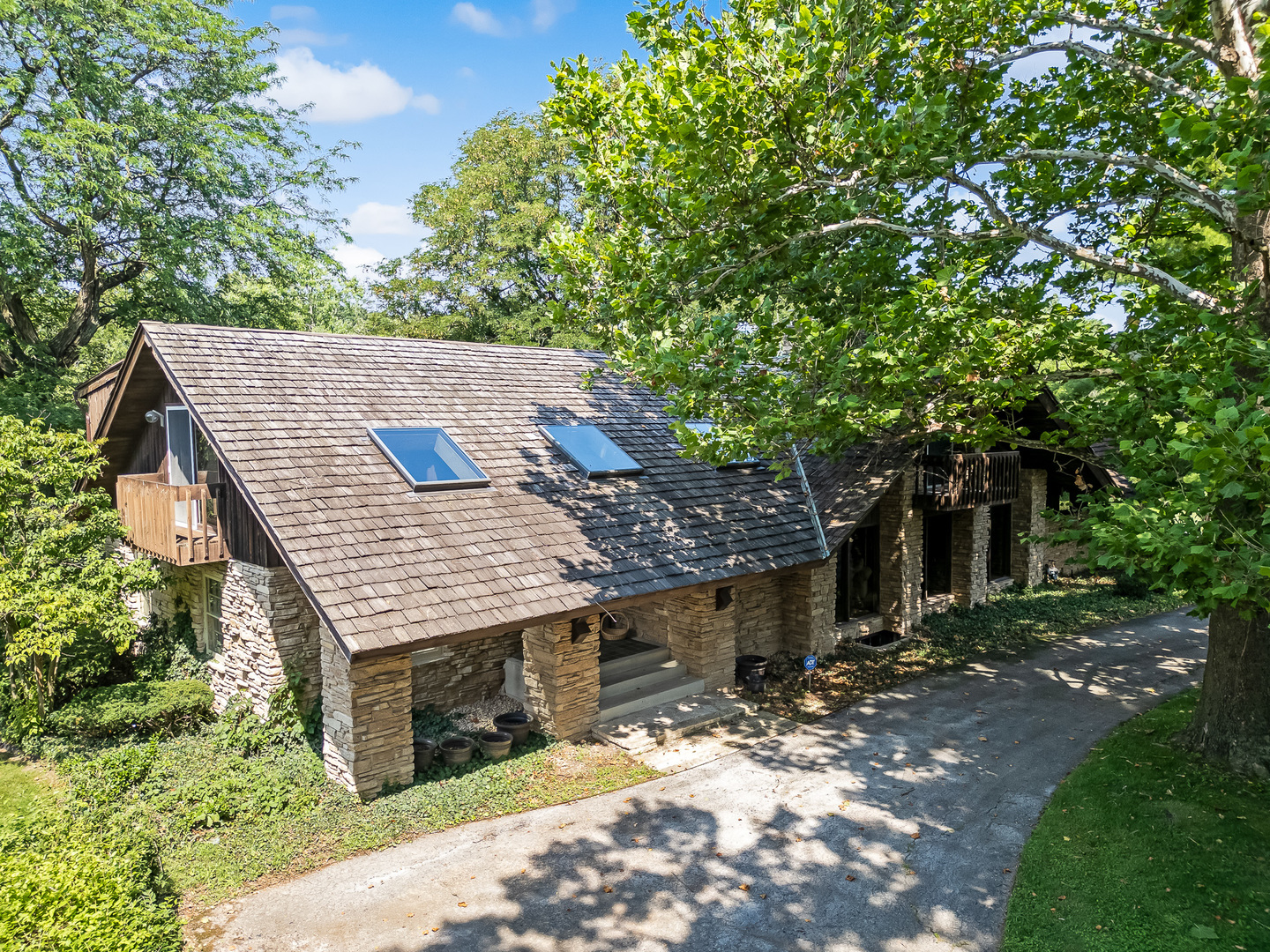 8080 Wolf Road Burr Ridge, IL 60527 - Photo 6 of 73 a view of a wooden house with a tree