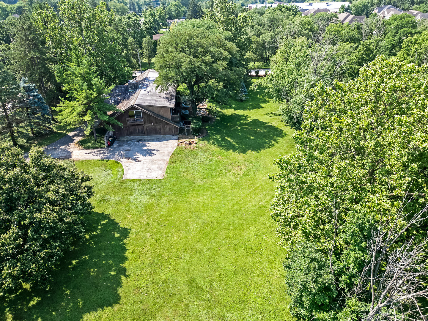 8080 Wolf Road Burr Ridge, IL 60527 - Photo 68 of 73 a backyard of a house with a yard and seating area