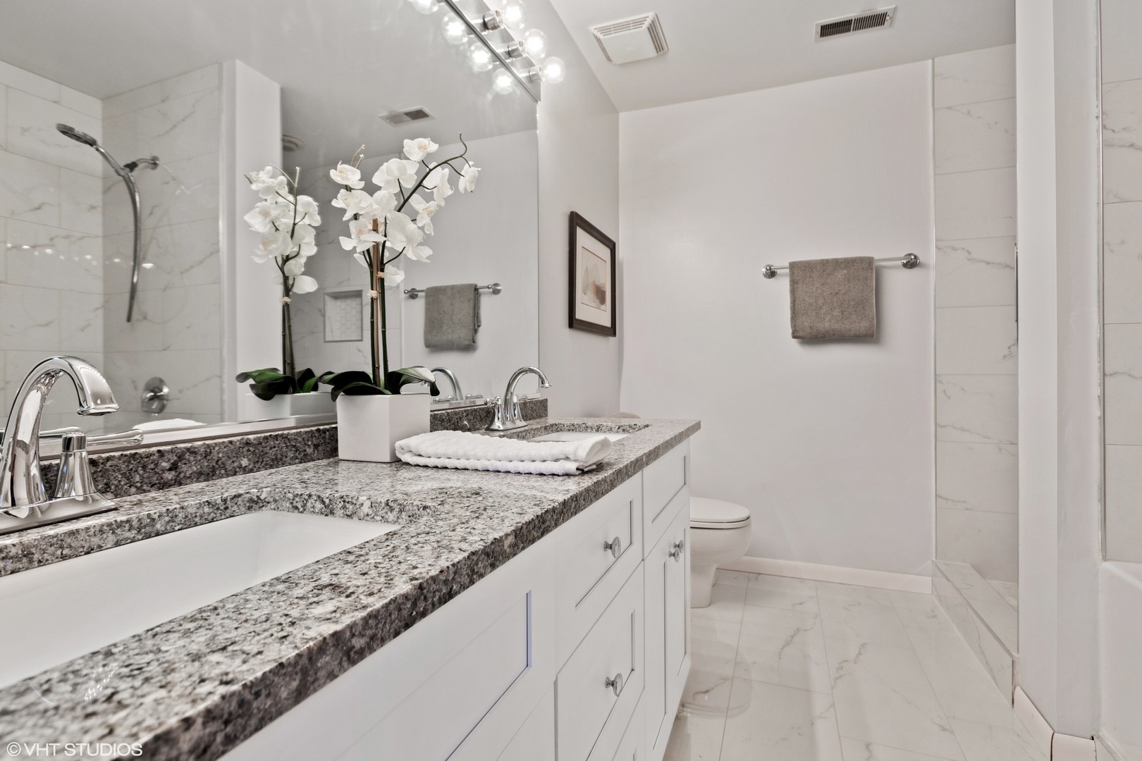 14 North Sangamon Street, Unit 309 Chicago, IL 60607 - Photo 14 of 39 a bathroom with a granite countertop sink a toilet and a mirror