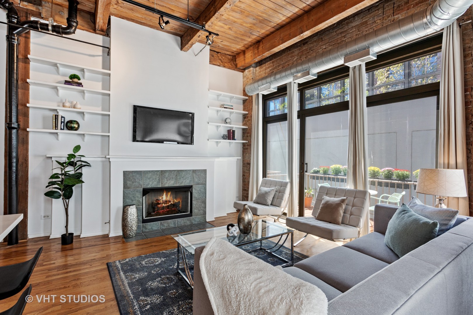 14 North Sangamon Street, Unit 309 Chicago, IL 60607 - Photo 25 of 39 a living room with furniture a flat screen tv and a fireplace