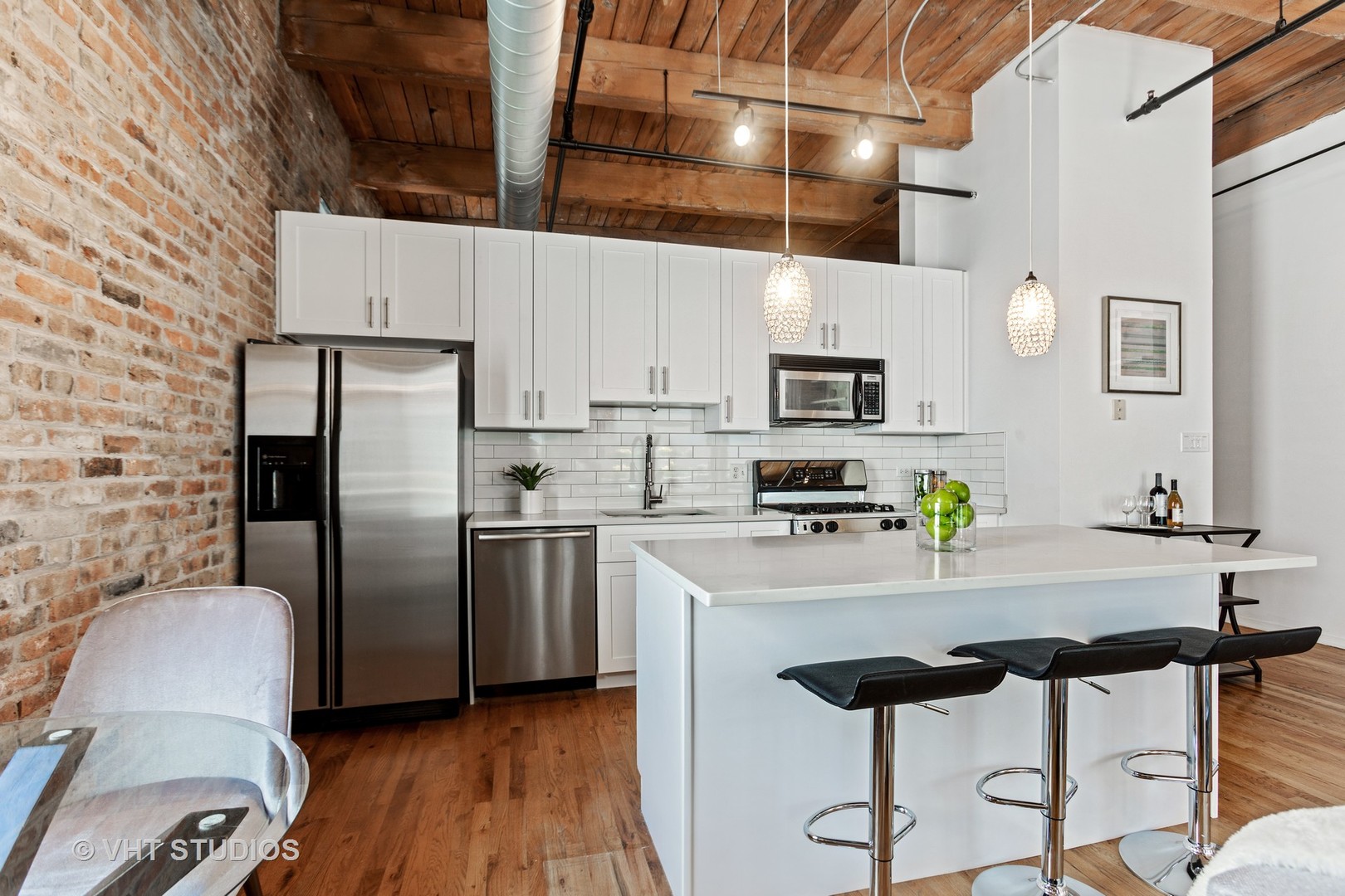 14 North Sangamon Street, Unit 309 Chicago, IL 60607 - Photo 27 of 39 a kitchen with stainless steel appliances a refrigerator a stove a sink dishwasher and white cabinets with wooden floor