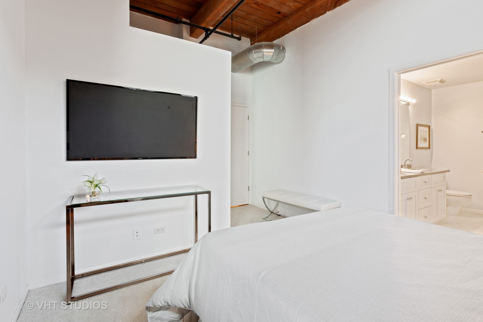 14 North Sangamon Street, Unit 309 Chicago, IL 60607 - Photo 32 of 39 a bedroom with a bed and a flat screen tv