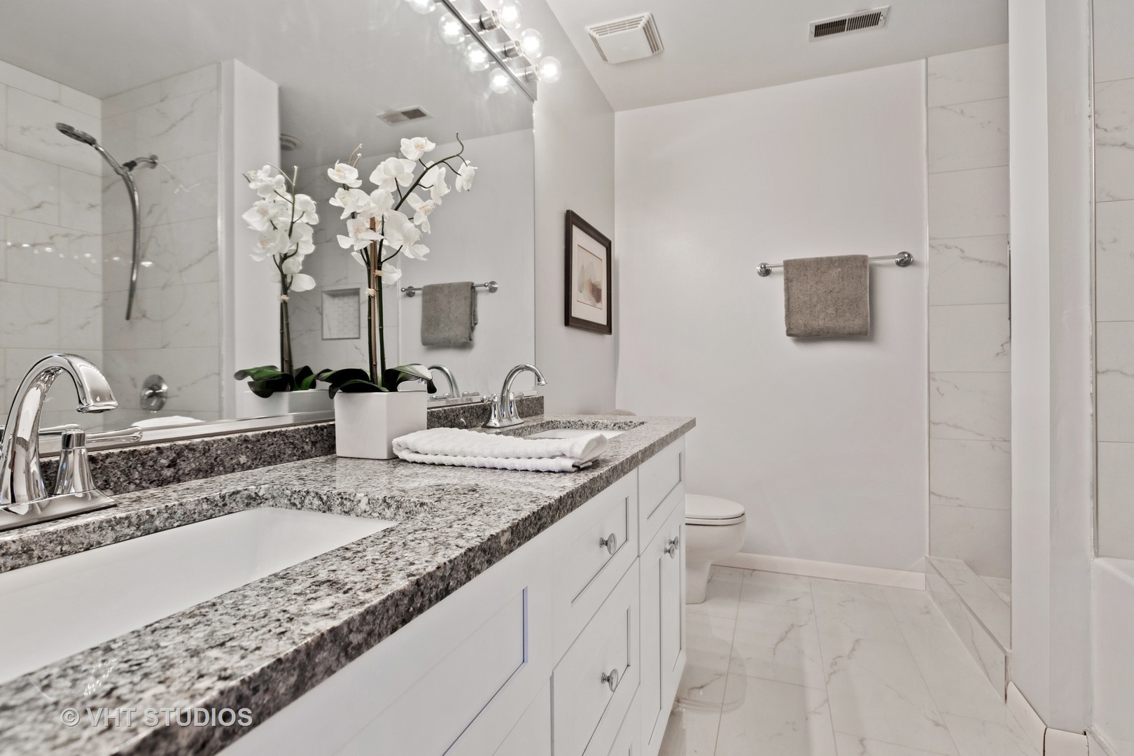 14 North Sangamon Street, Unit 309 Chicago, IL 60607 - Photo 33 of 39 a bathroom with a granite countertop sink a toilet and a mirror