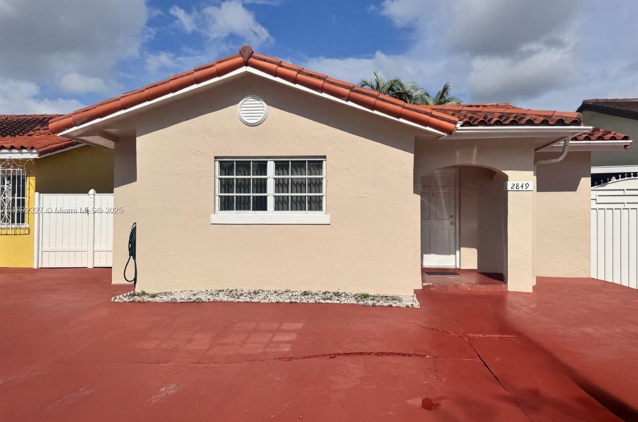 2849 West 71st Street Hialeah, FL 33018 - Photo 3 of 22 a front view of a house with a yard