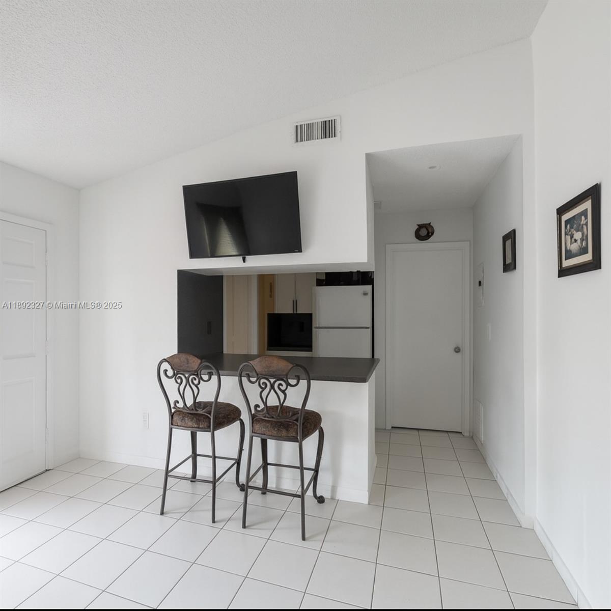 2849 West 71st Street Hialeah, FL 33018 - Photo 5 of 22 a view of a livingroom with furniture and a flat screen tv