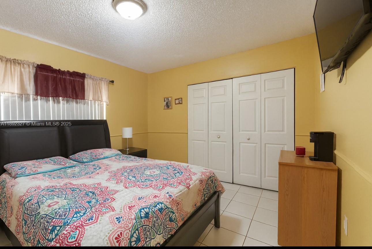 2849 West 71st Street Hialeah, FL 33018 - Photo 7 of 22 a bedroom with a bed and a cabinets