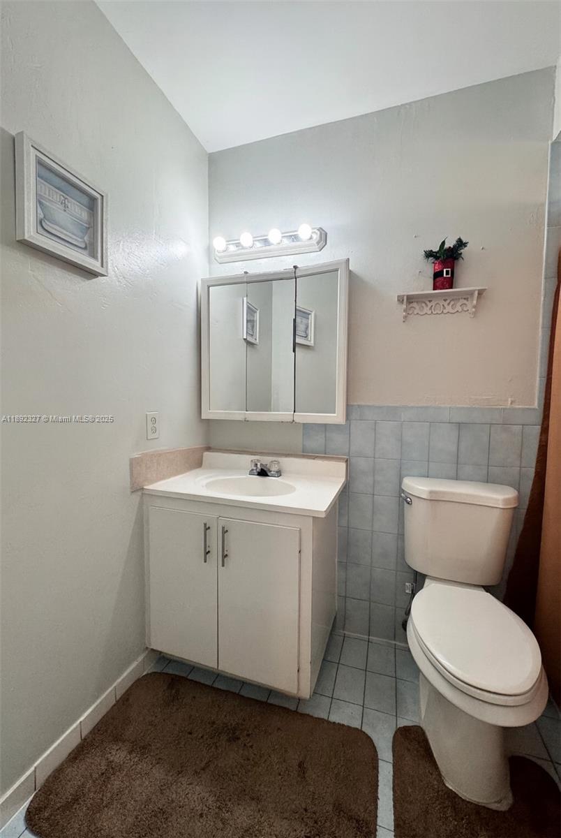 2849 West 71st Street Hialeah, FL 33018 - Photo 8 of 22 a bathroom with a toilet sink and mirror