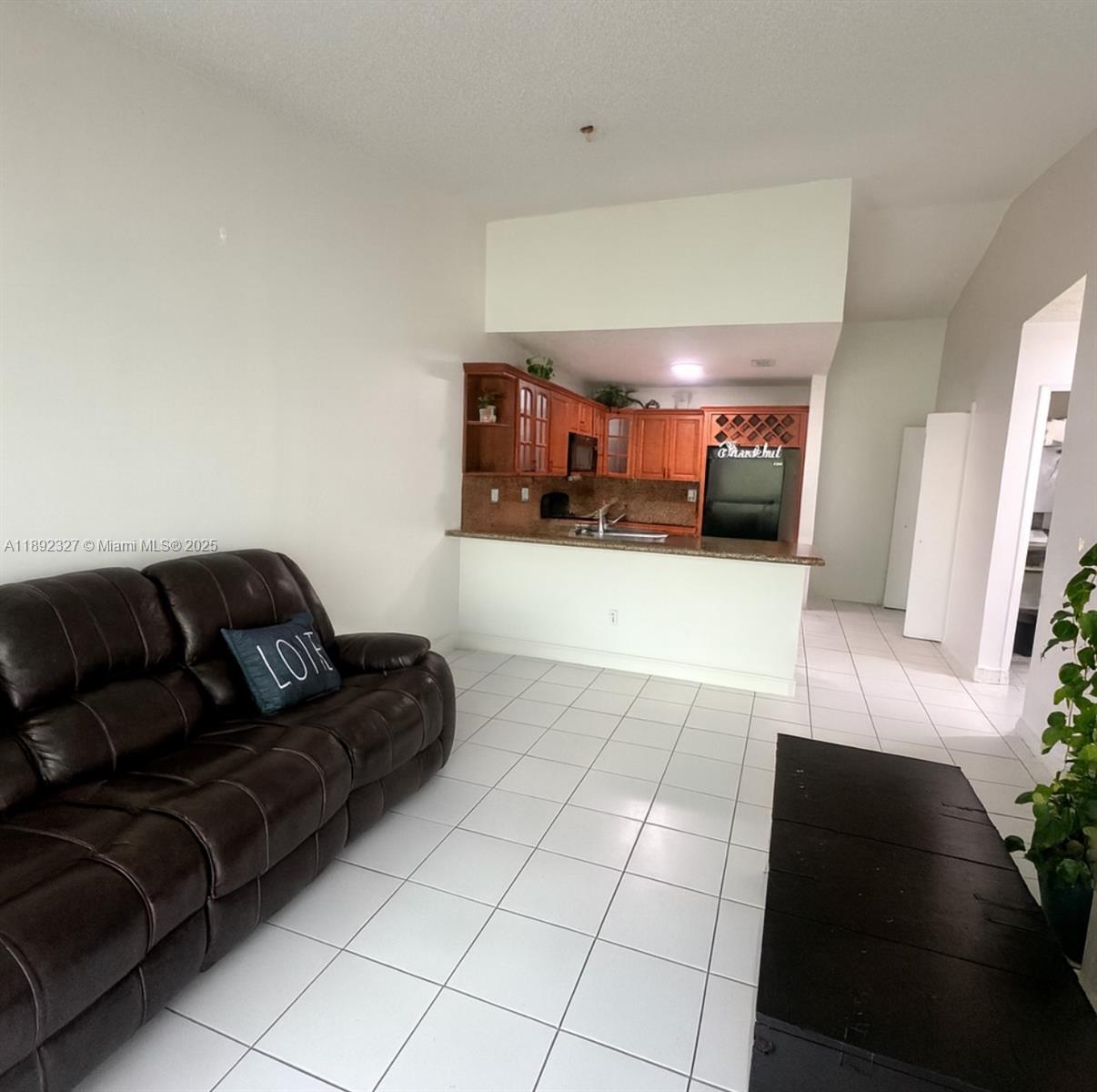 2849 West 71st Street Hialeah, FL 33018 - Photo 10 of 22 a living room with furniture and a flat screen tv