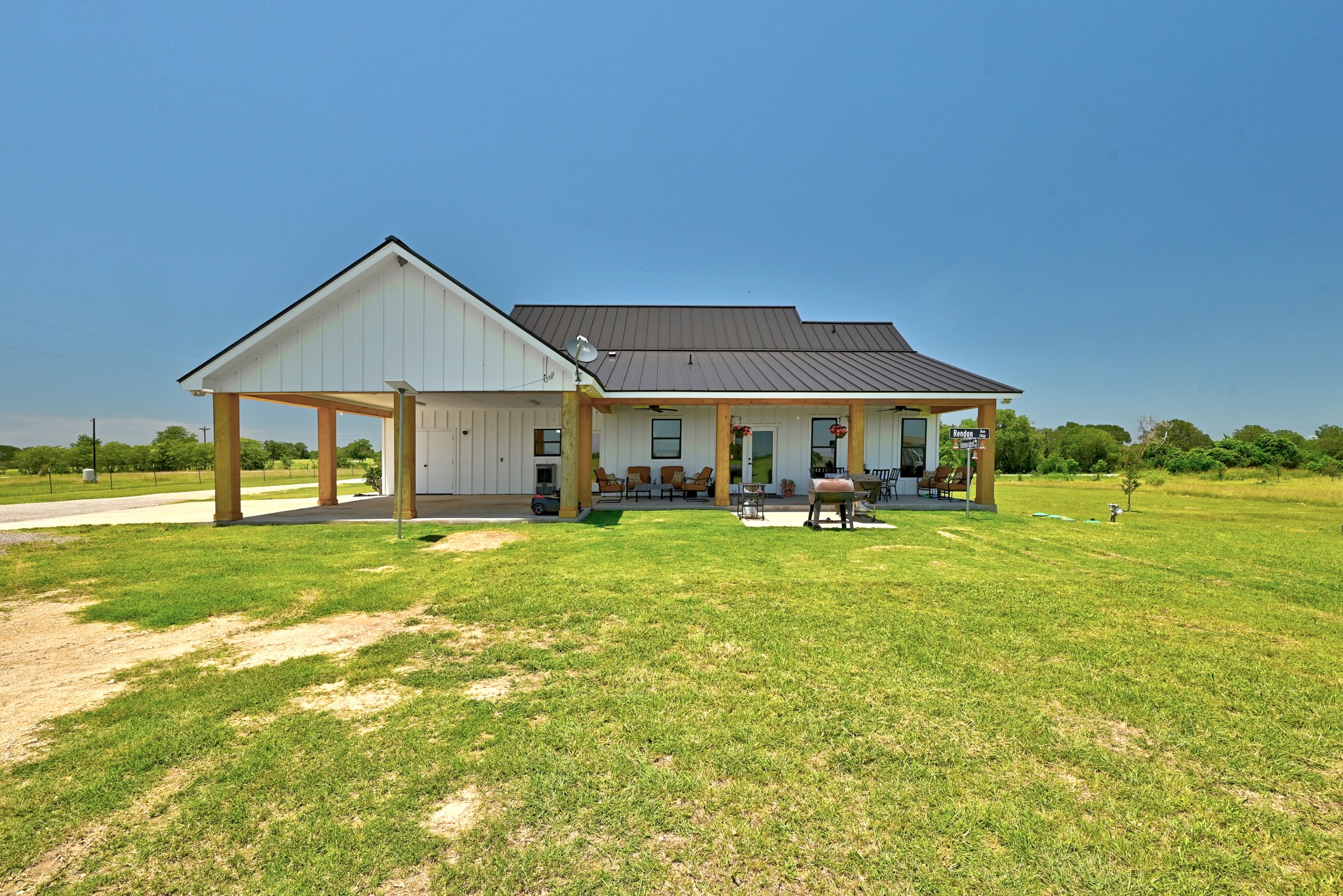 2889 Old McMahan Road Lockhart, TX 78644 - Photo 28 of 33 A striking modern farmhouse with expansive porch living and a detached carport.