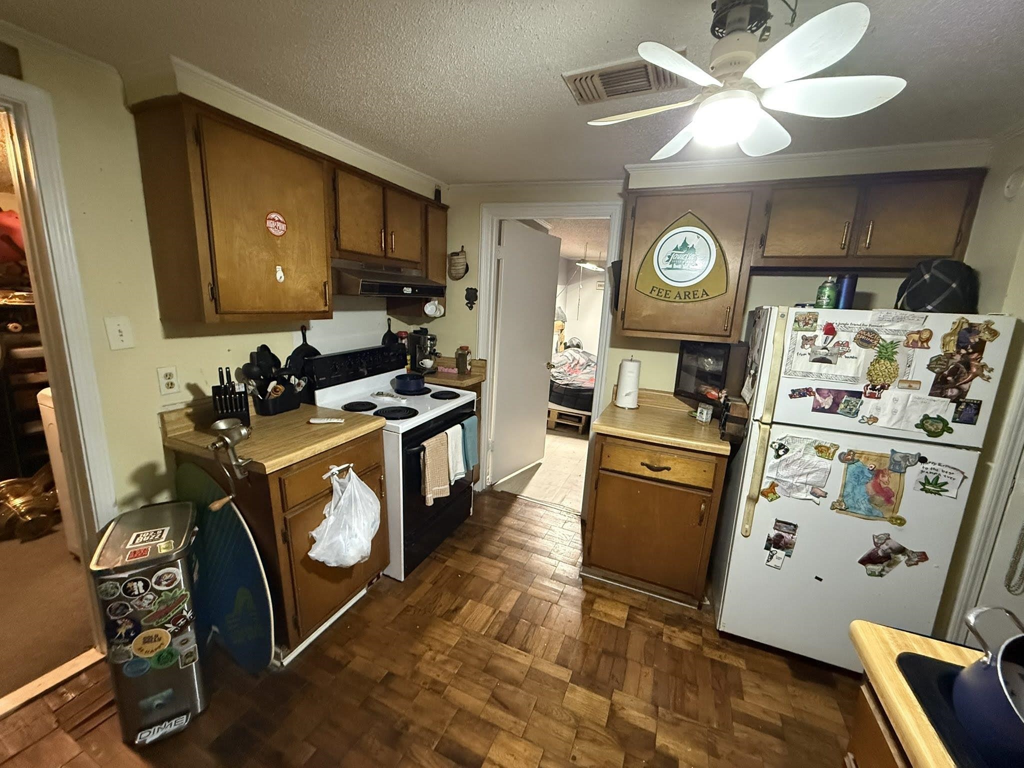 7503 Walsh Road Millington, TN 38053 - Photo 7 of 26 Kitchen featuring wood-finish flooring, wood cabinetry, a four-burner electric range, and a ceiling fan with integrated lighting