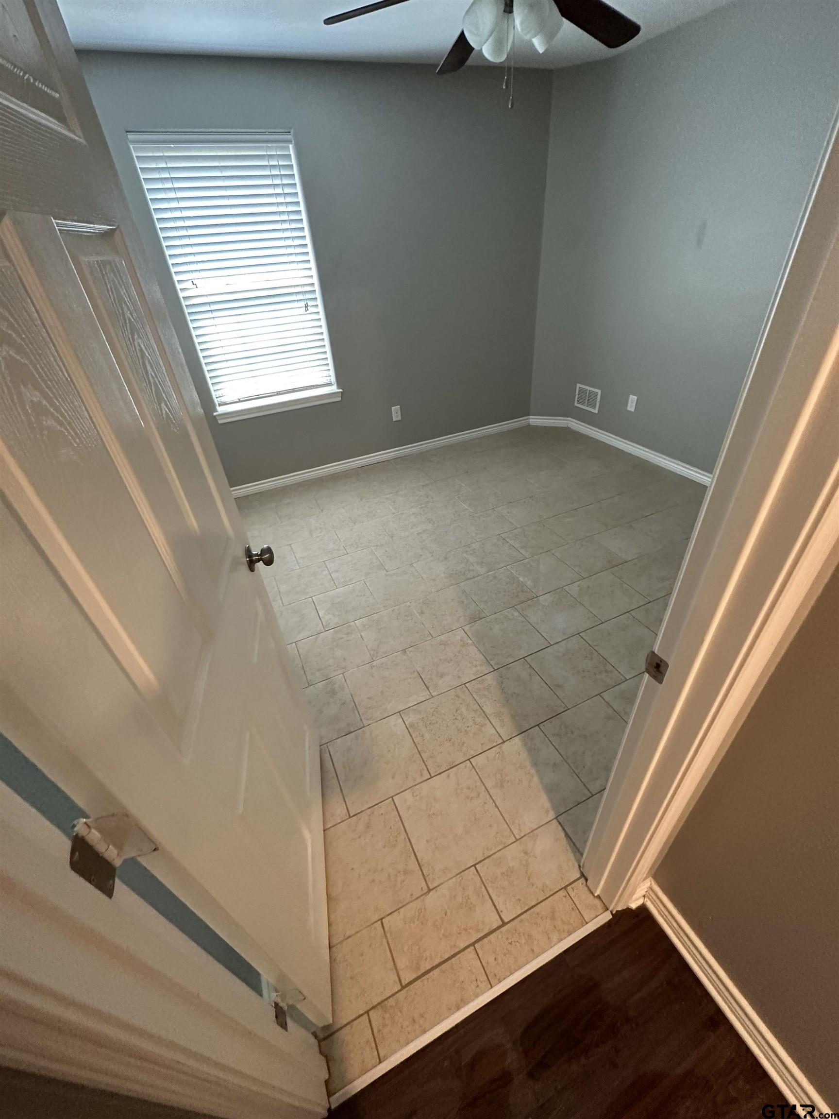 3960 Cottage Drive Tyler, TX 75701 - Photo 13 of 15 a view of an empty room with a window