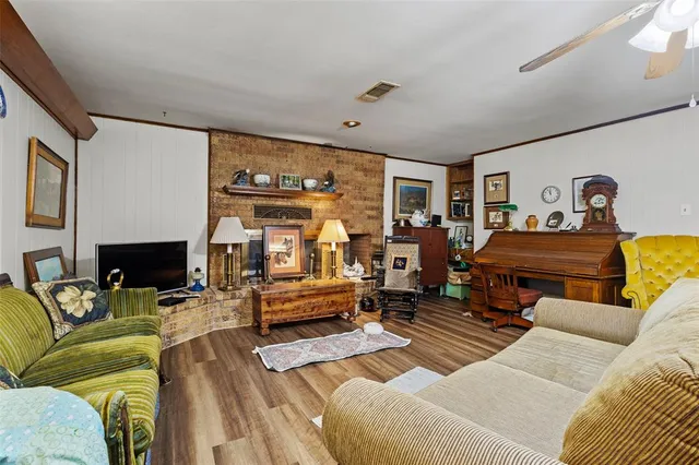 a living room with furniture a fireplace and a flat screen tv