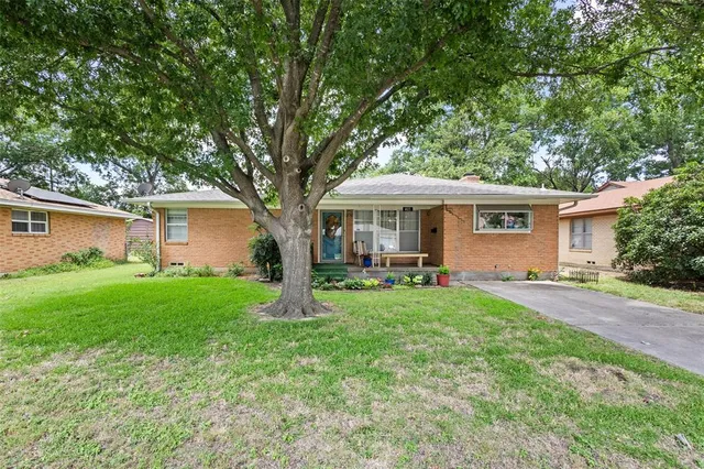 a view of a house with a yard and sitting area