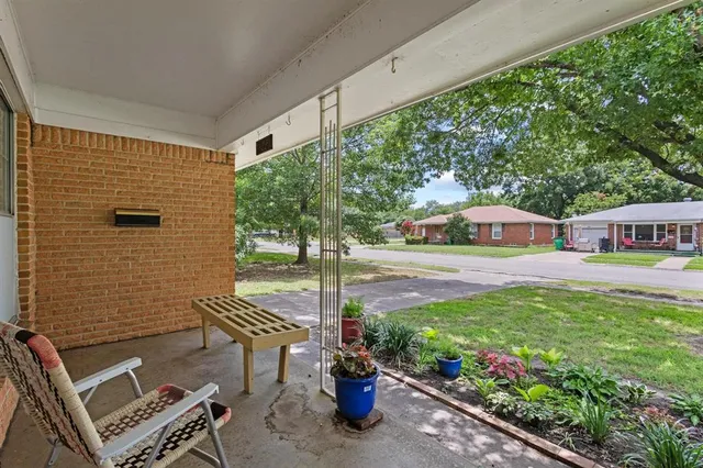 a view of a chairs and table in backyard of the house